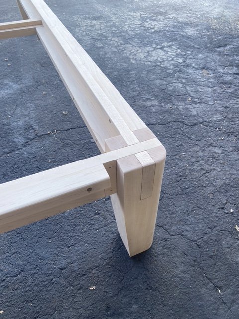 Joinery detail from a handcrafted wood bed frame