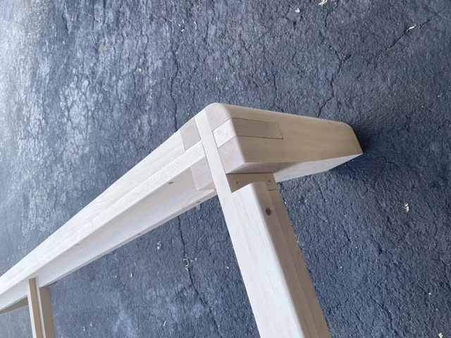 Joinery detail from a handcrafted wood bed frame