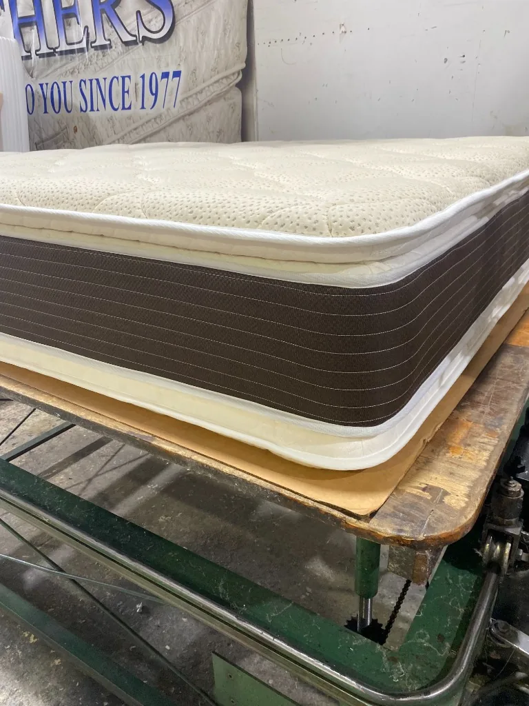 Dual-sided pillow top mattress on the Maylin Mattress production table