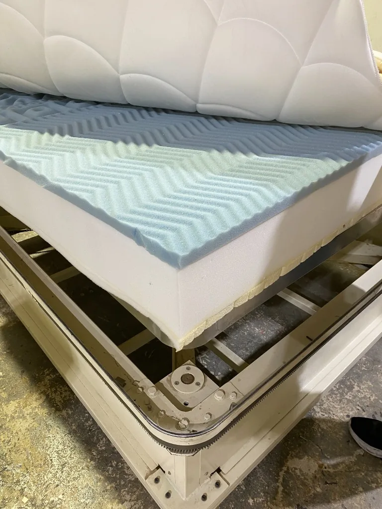Adding the quilted top layer to the high density foam
