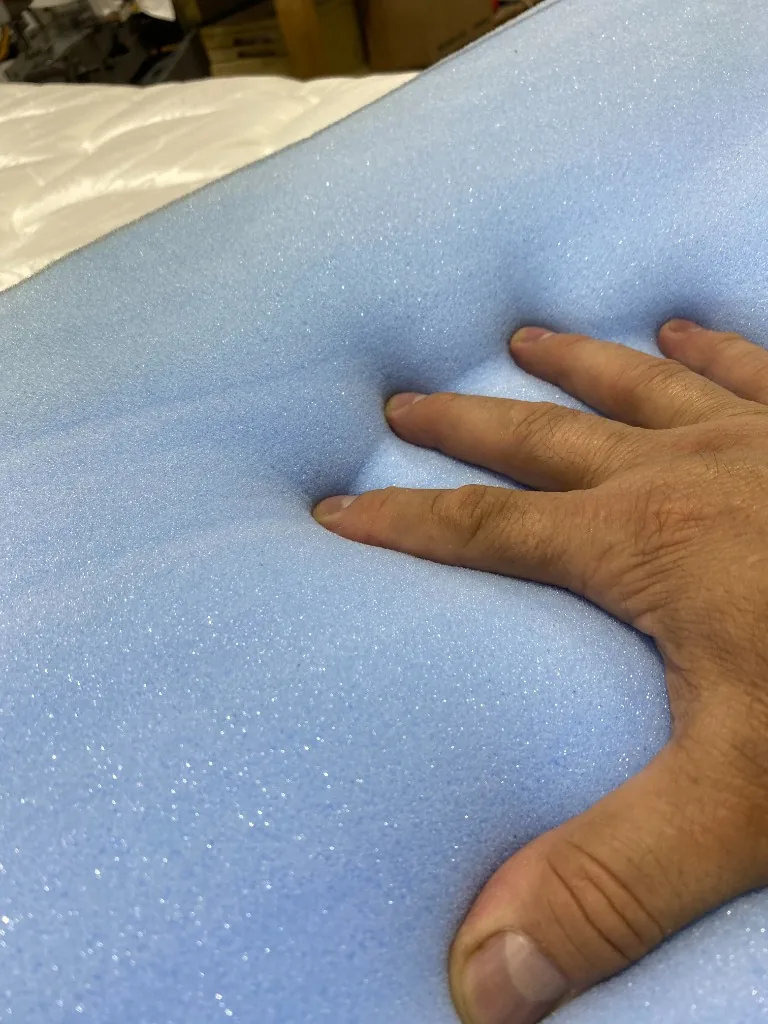 Hand pressing into the high density foam to test firmness