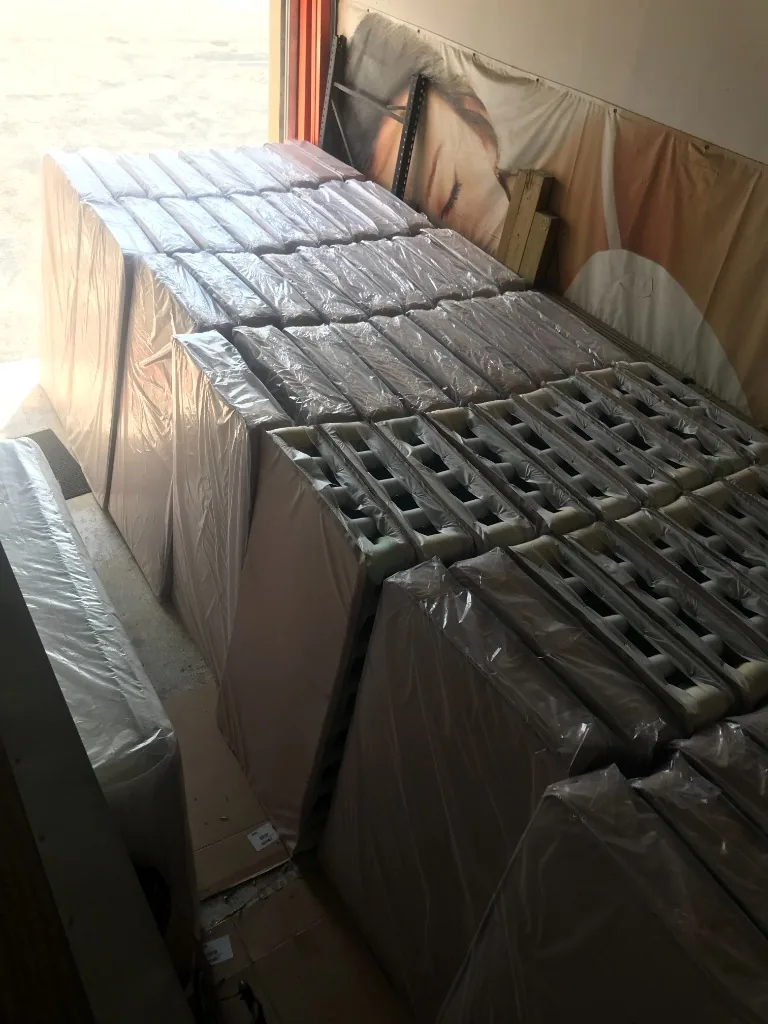 Stacks of wrapped spring mattresses in the warehouse